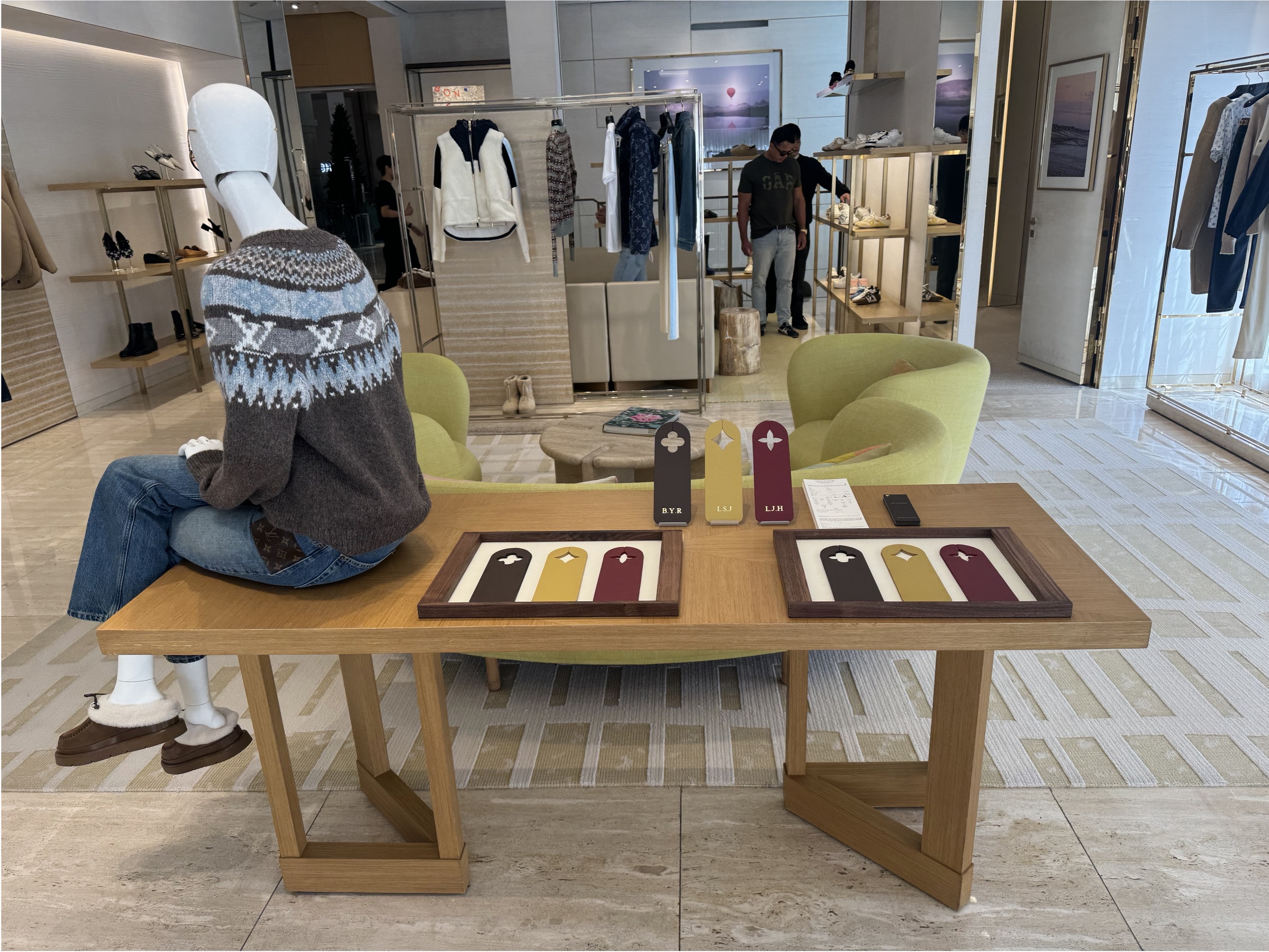 Louis Vuitton boutique interior with framed displays of colored leather tags with Monogram flower cut-outs