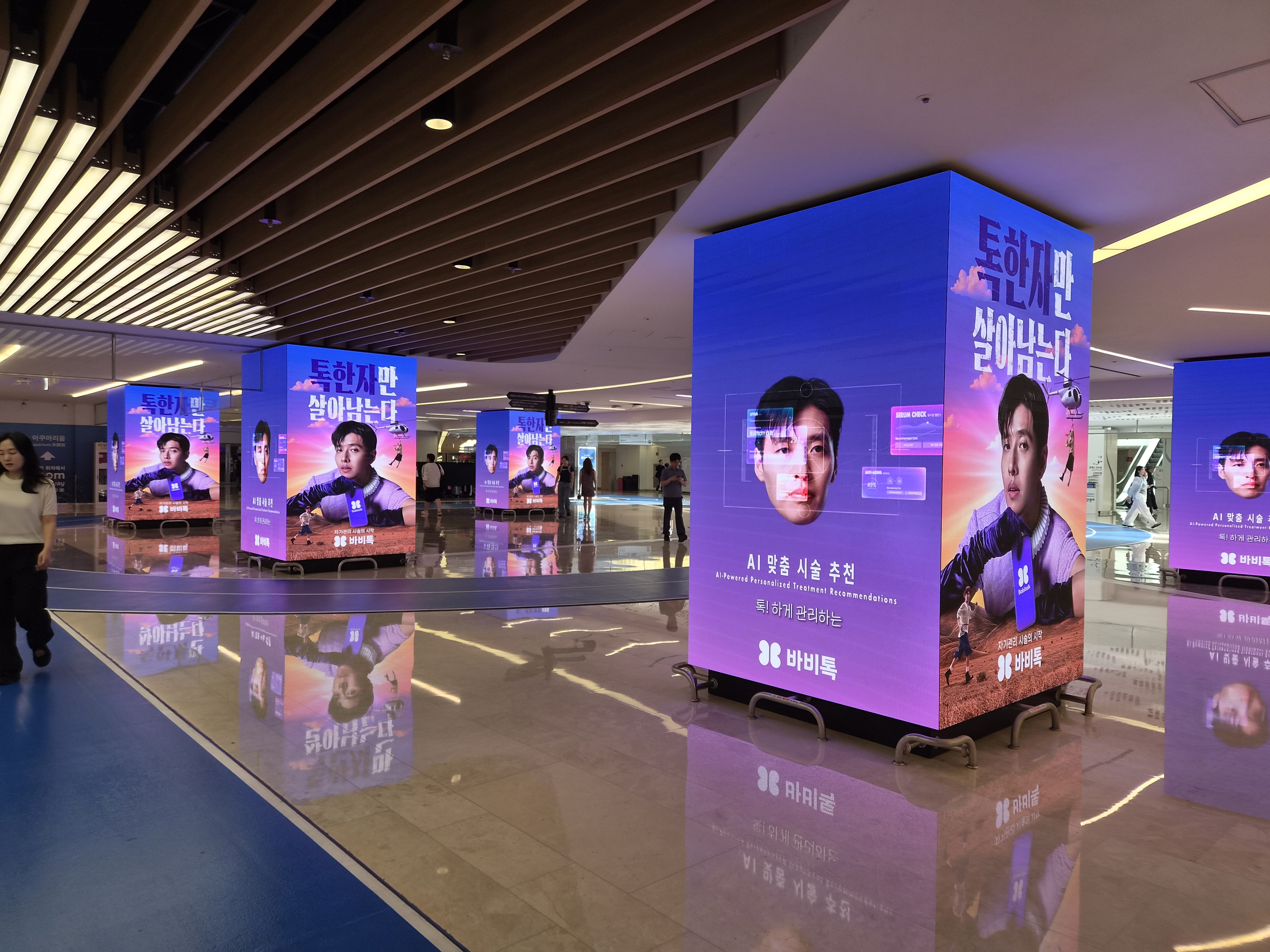 BABITALK AI treatment recommendation creative on a large COEX 9TO9 digital cube with more displays behind, Seoul