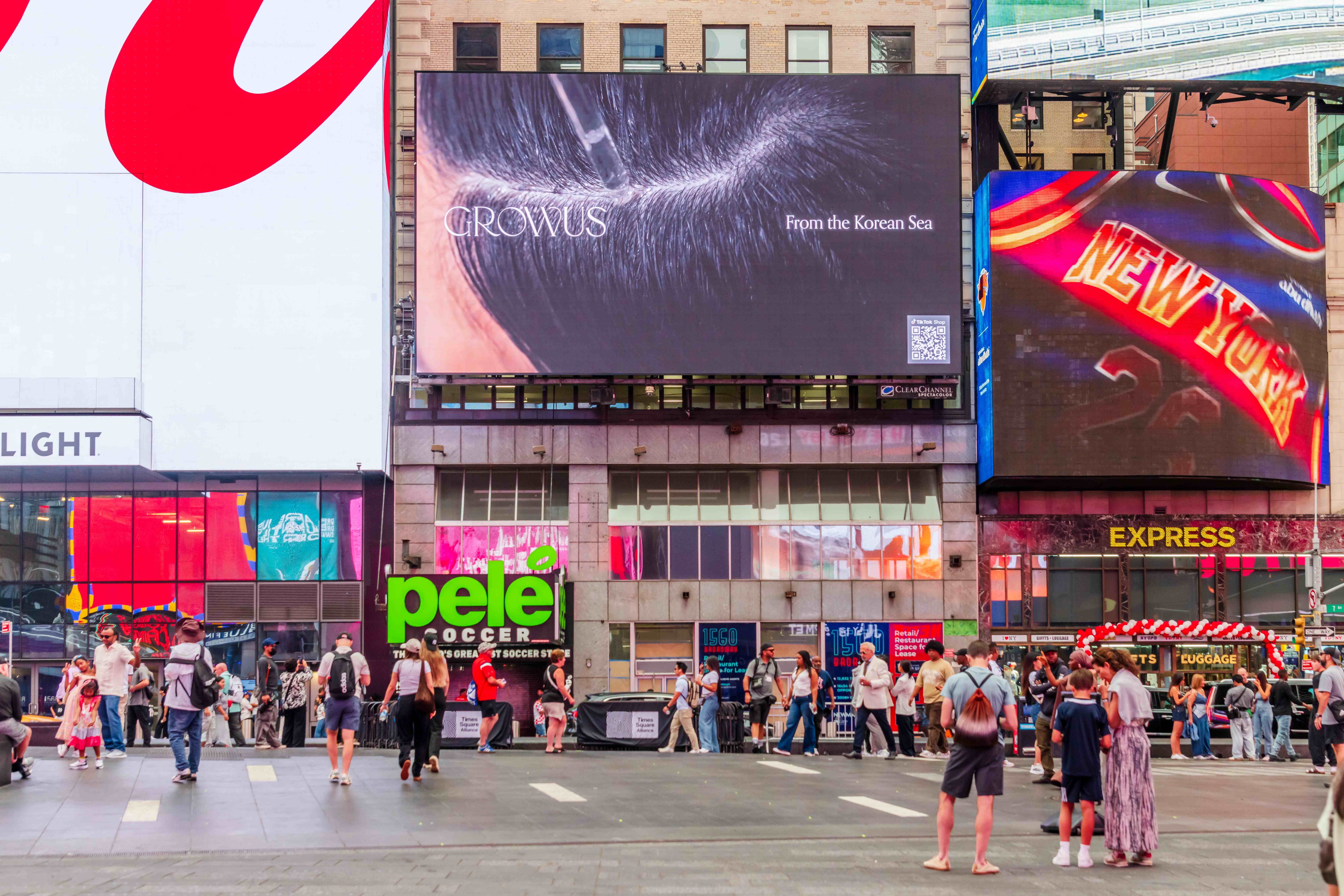 GROWUS "From the Korean Sea" creative on the 1560 Broadway digital billboard above Times Square pedestrians, New York