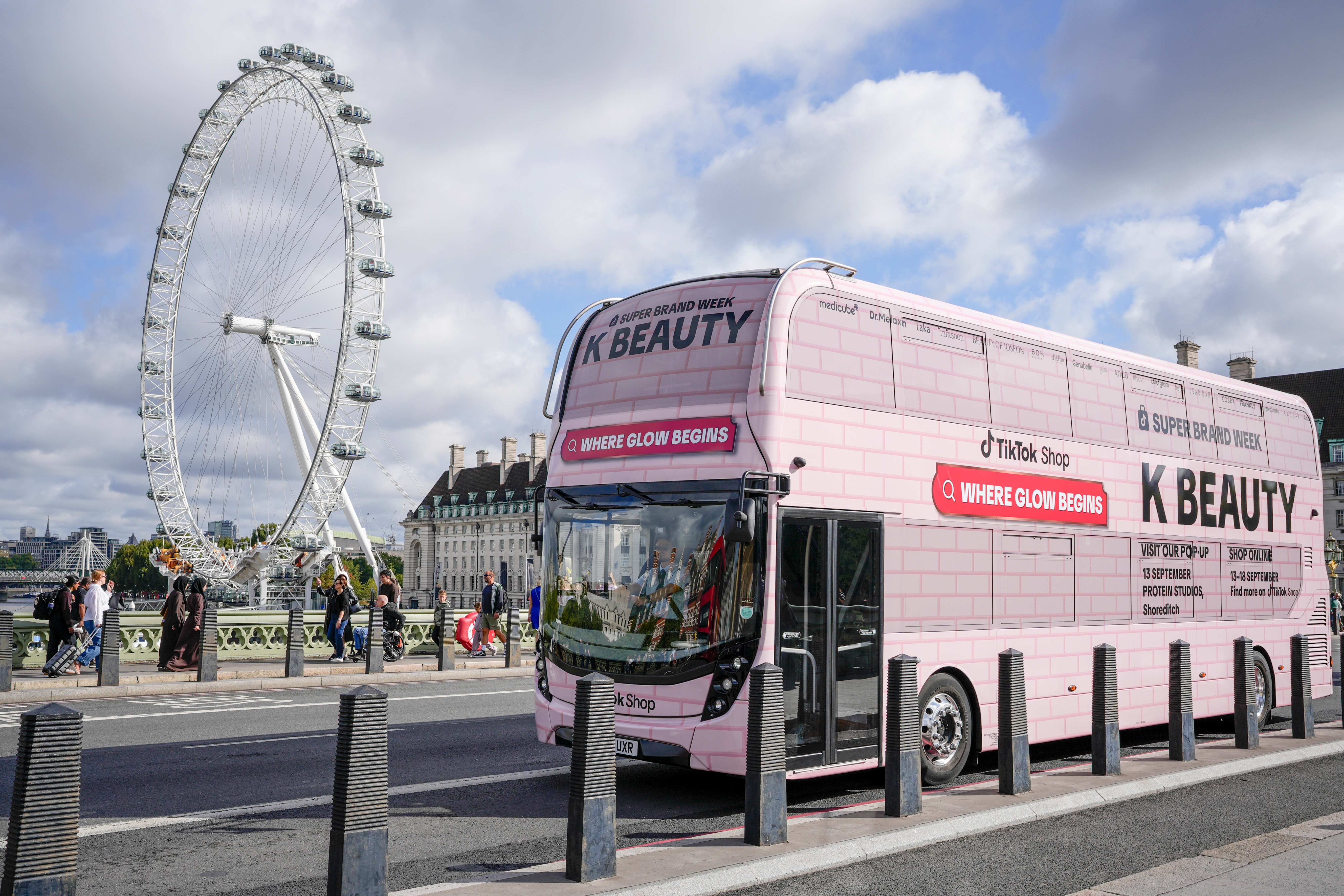 TikTok Shop K-BEAUTY "Where Glow Begins" bus on Westminster Bridge with the London Eye behind