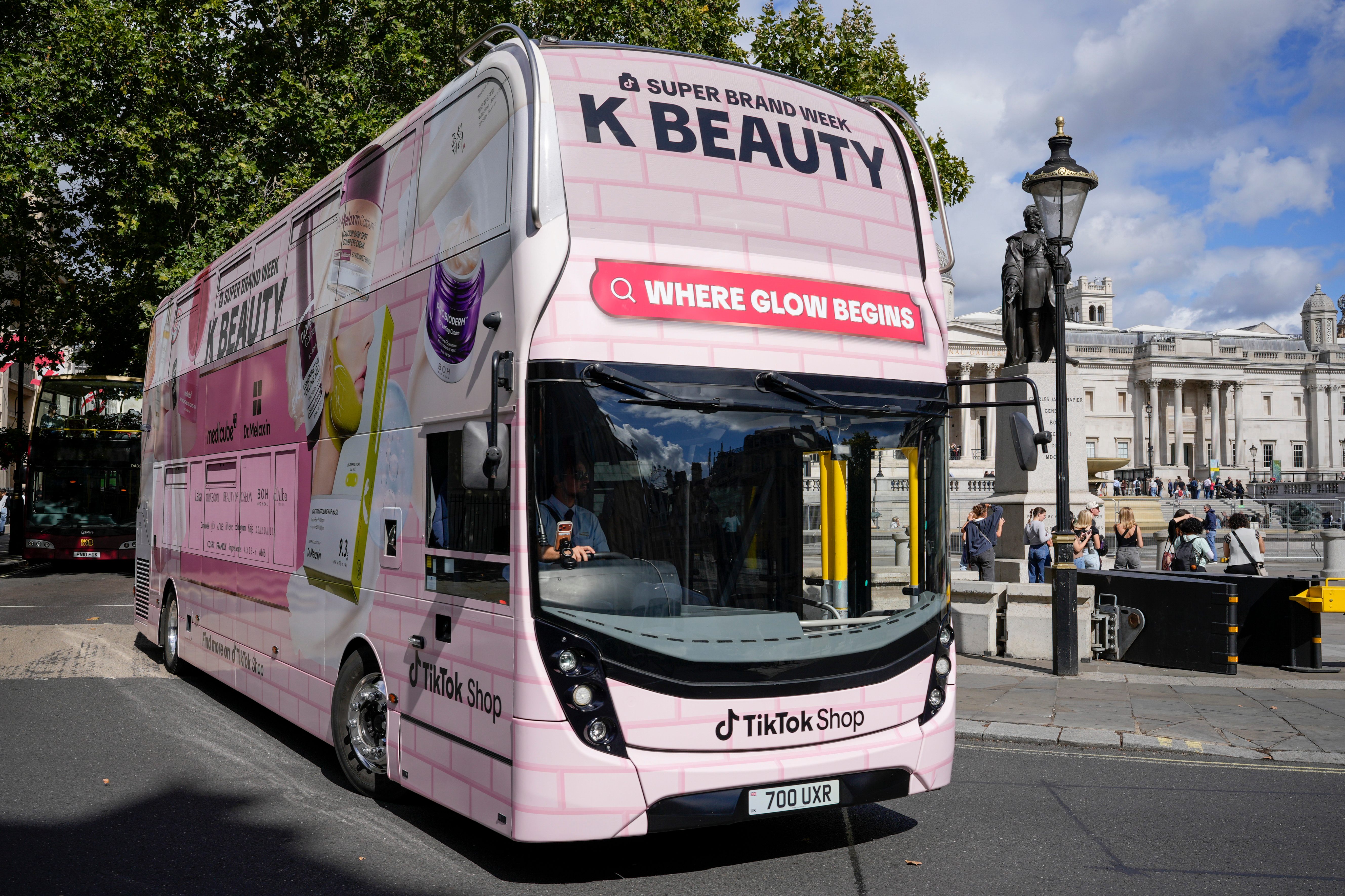Front of the K-BEAUTY "Where Glow Begins" bus at Trafalgar Square