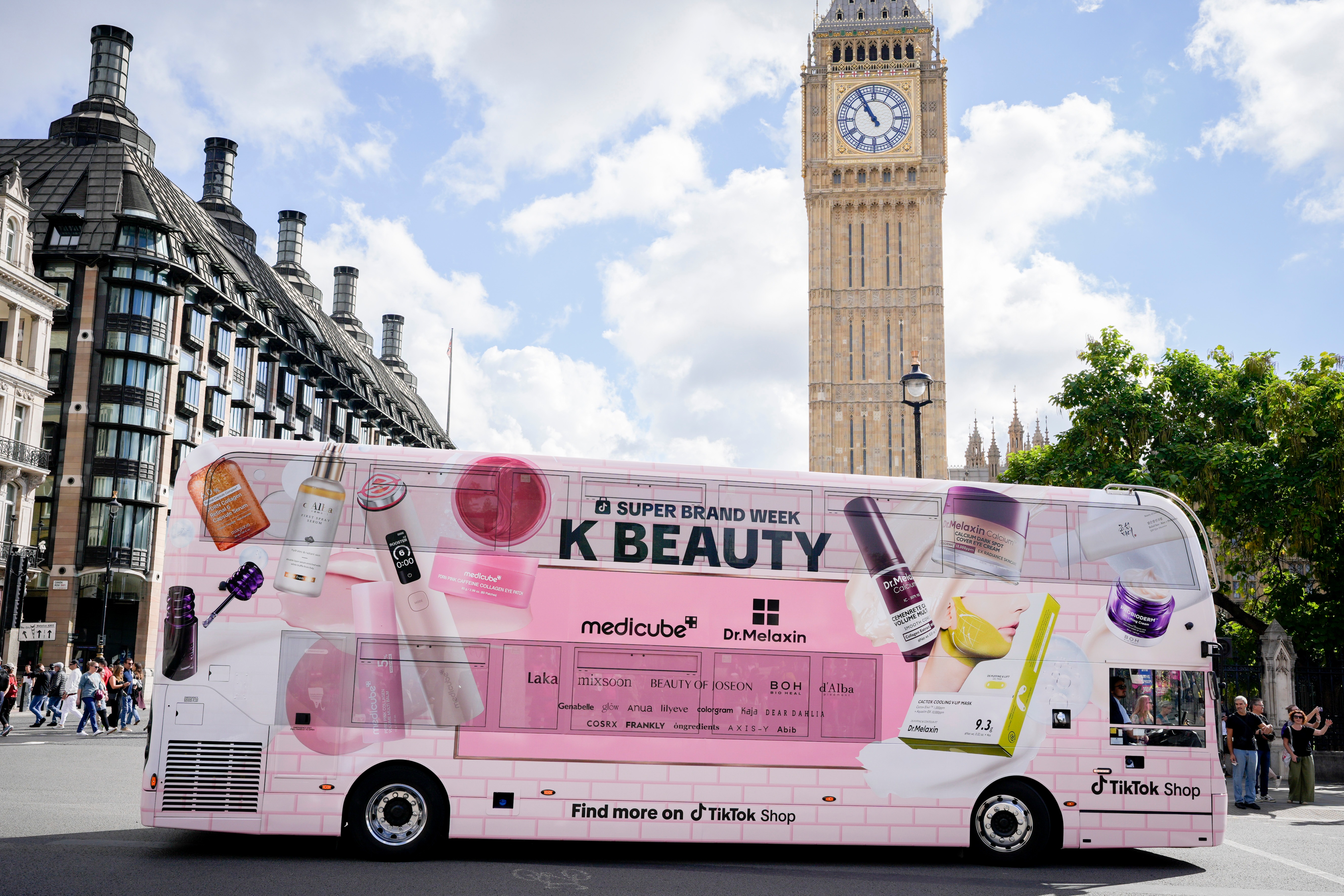 Full side wrap of the K-BEAUTY bus in front of Big Ben