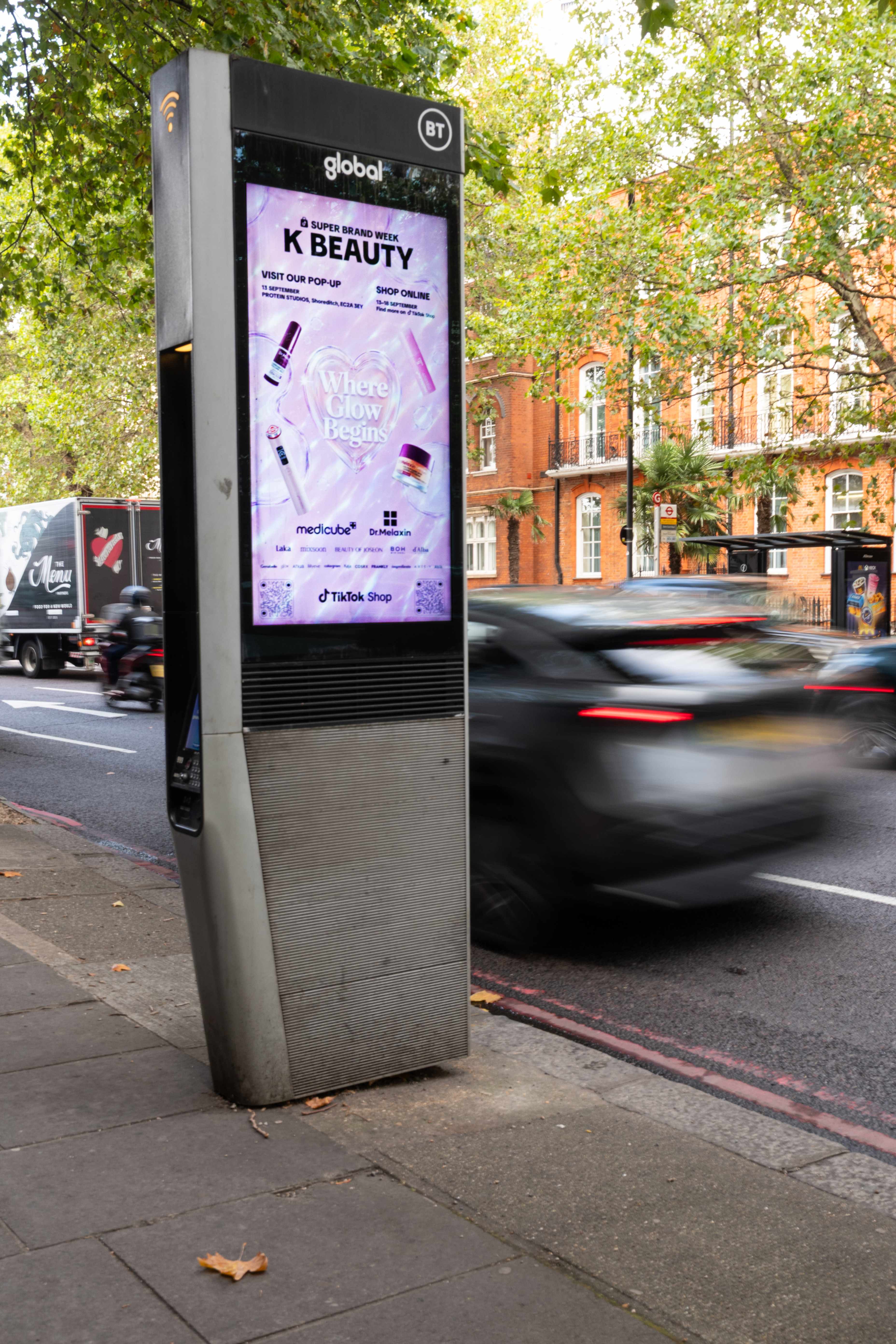 TikTok Shop K-BEAUTY creative on a BT StreetHub kiosk with traffic passing