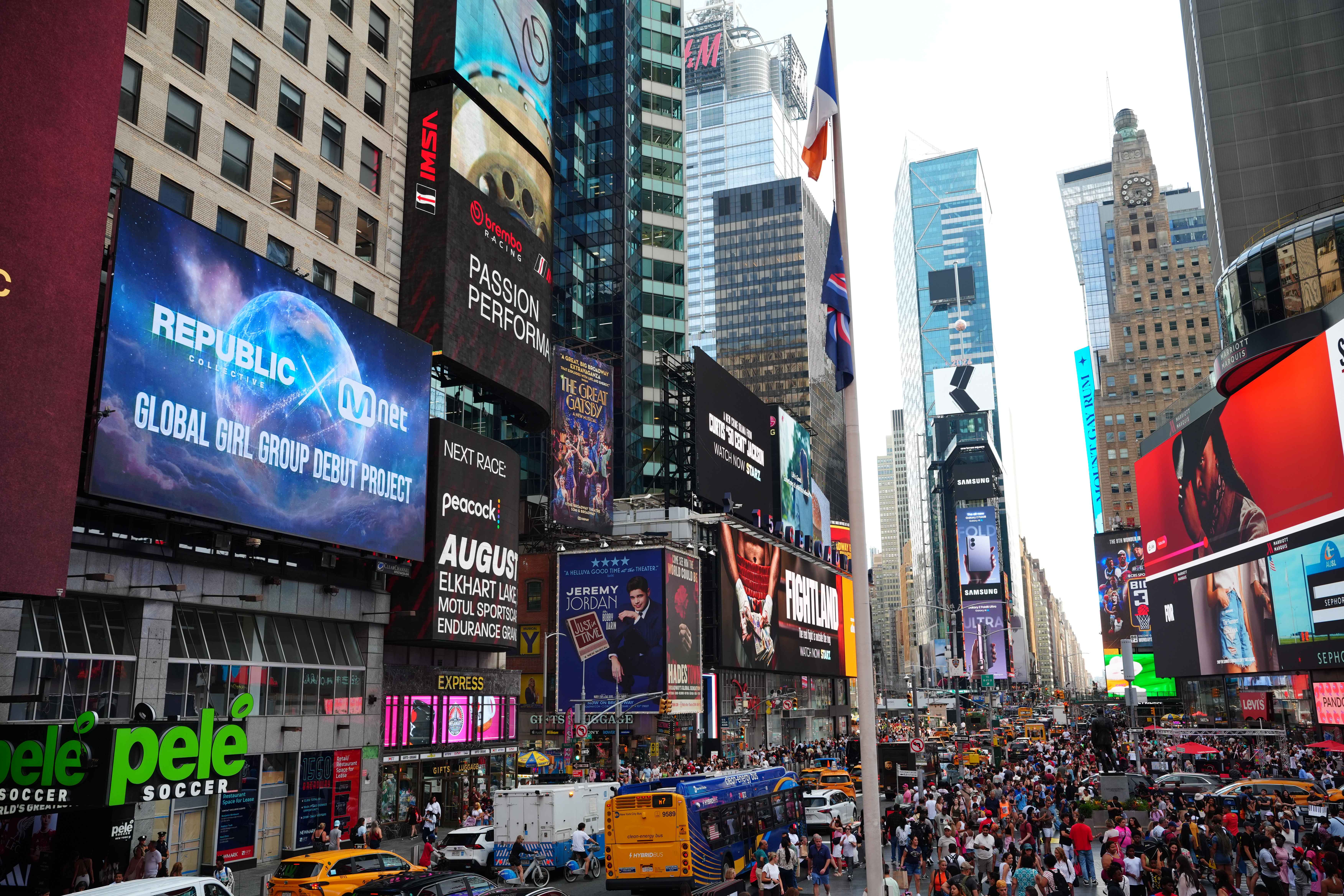 Republic Collective x Mnet Global Girl Group Debut Project screen within the wider Times Square skyline