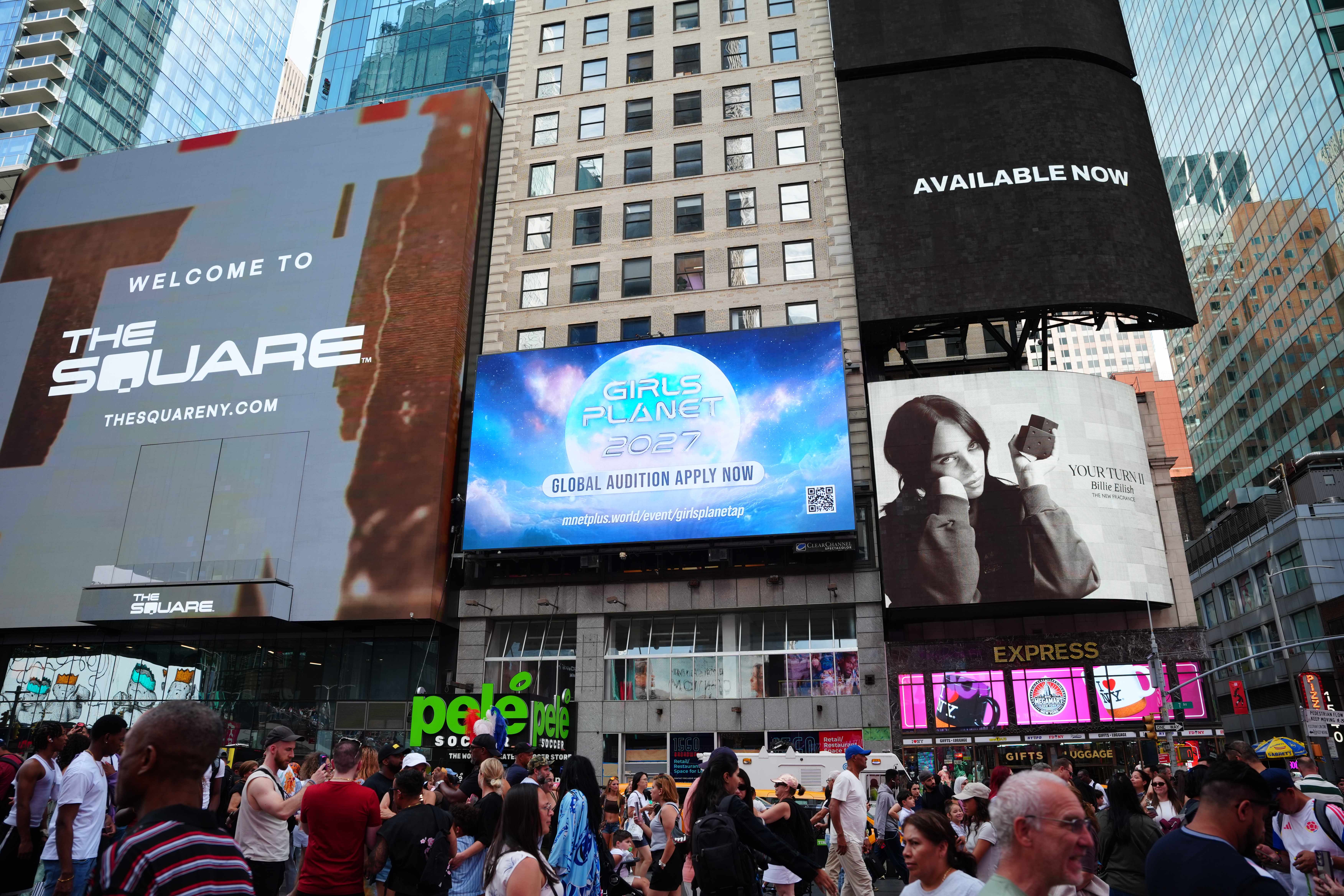 Closer view of the Mnet Girls Planet 2027 Global Audition screen above the Times Square crowd