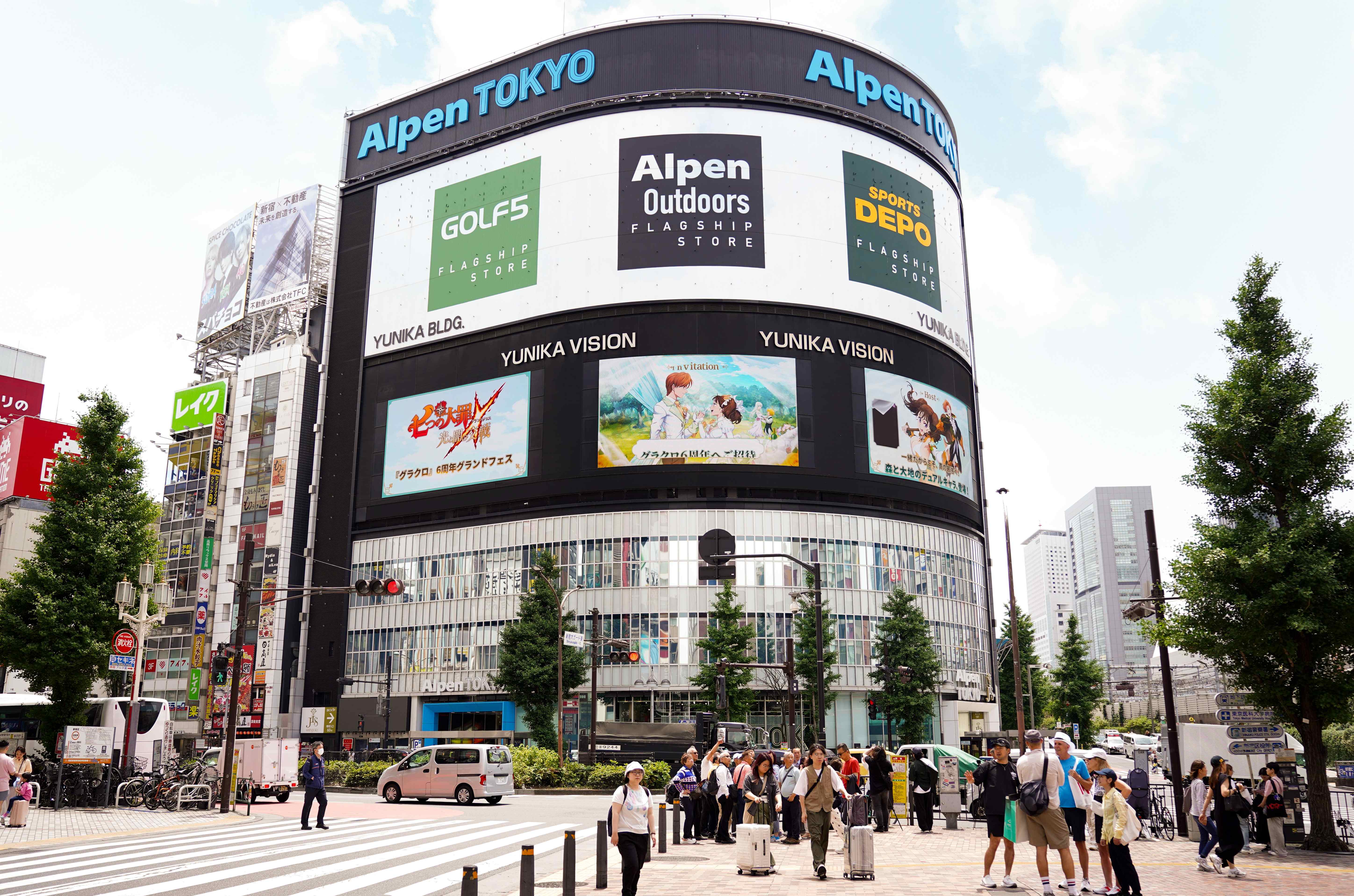 Netmarble campaign on the Yunika Vision screens of the Alpen Tokyo building above a Shinjuku crossing, Tokyo
